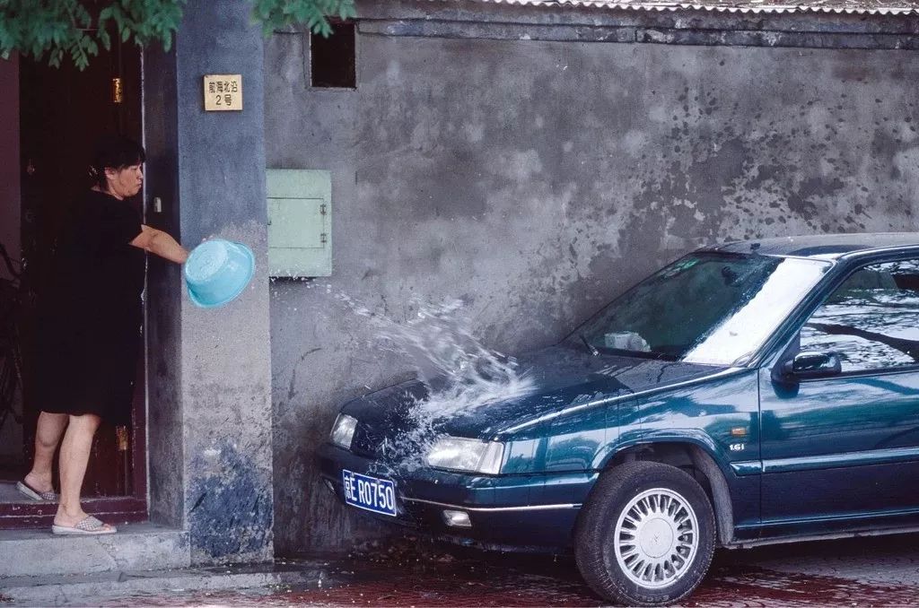 1999年，北京后海胡同里停放的私家車。 上世紀(jì)90年代，中國(guó)汽車產(chǎn)業(yè)相對(duì)封閉，可供選擇的車型并不豐富，價(jià)格也不便宜。嚴(yán)志剛攝影像見(jiàn)證四十年.jpg